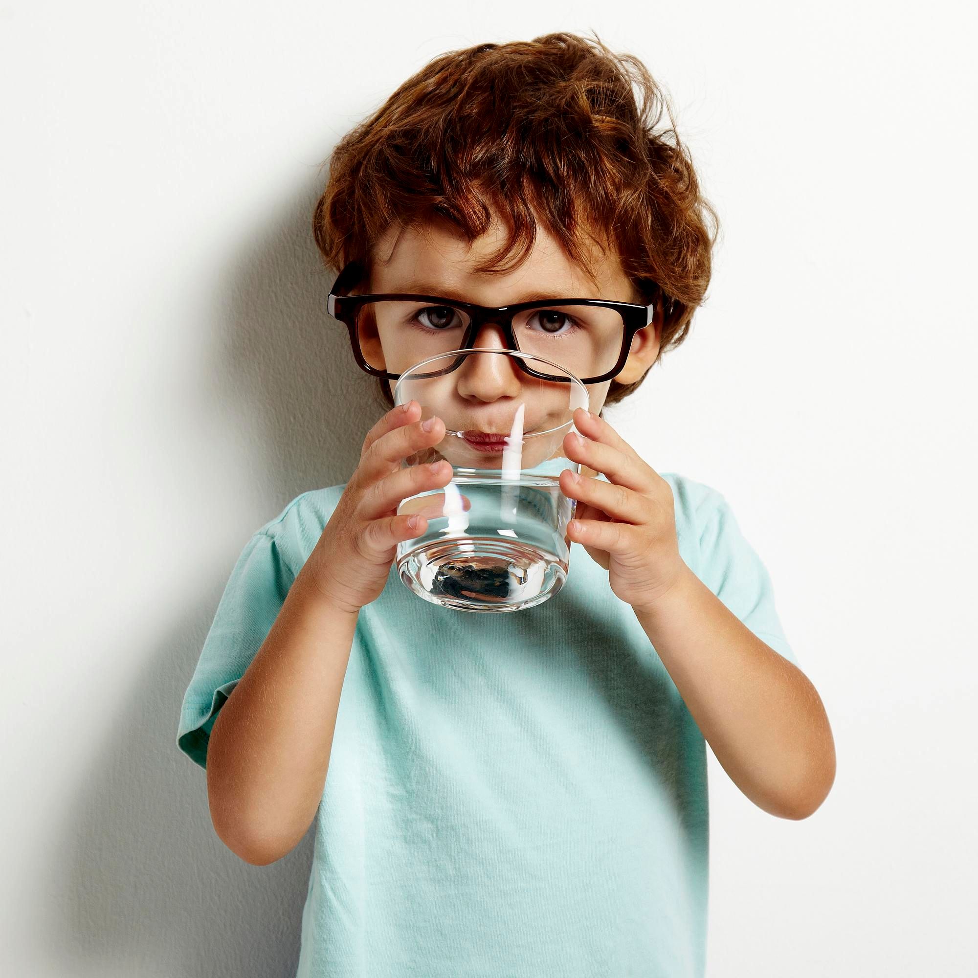 A child drinking water from a glass