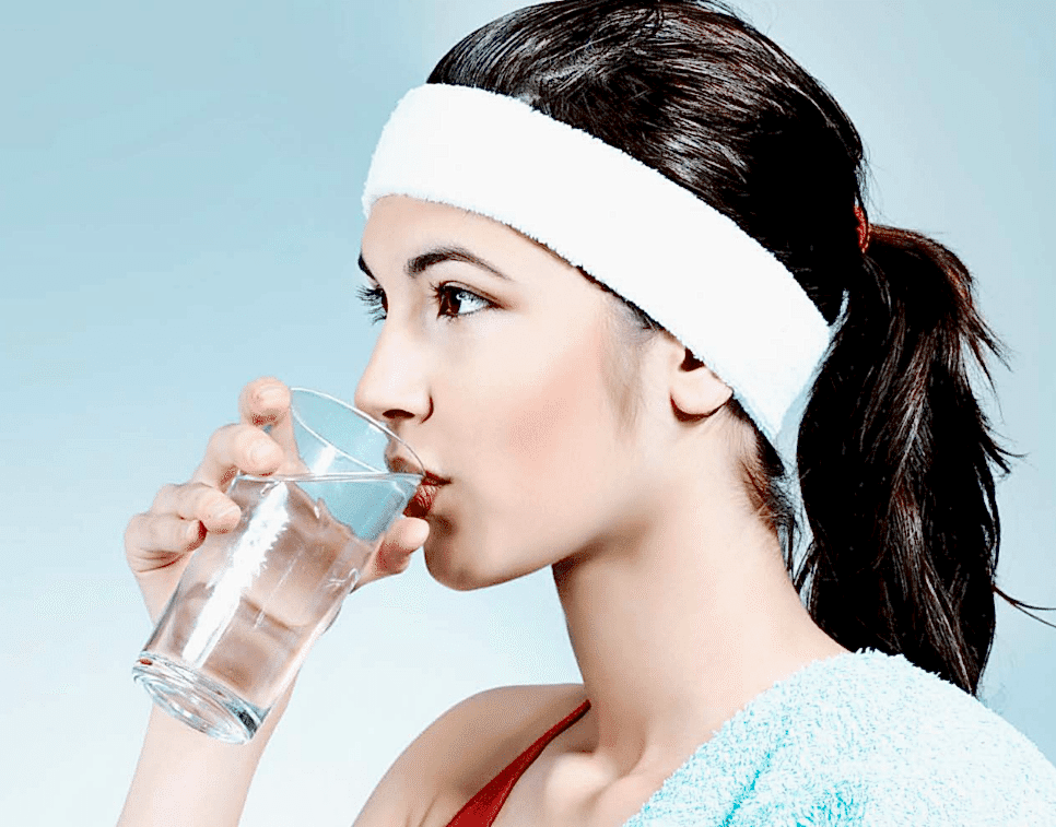 A Girl Drinking Water From A Clear Glass